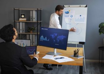business-person-looking-finance-graphs-min